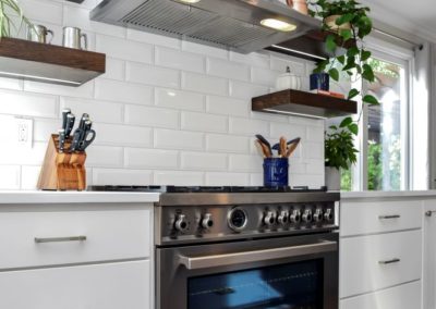 White kitchen cabinets with stove hood